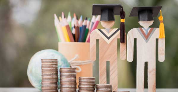 grad cutouts in wood behind stacks of coins